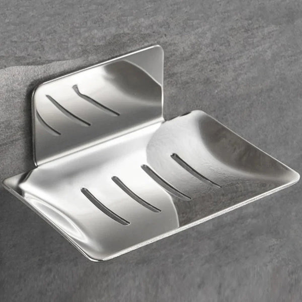 Saboneteira de parede em aço inox prateado com bandeja vazada, fixada no azulejo do box